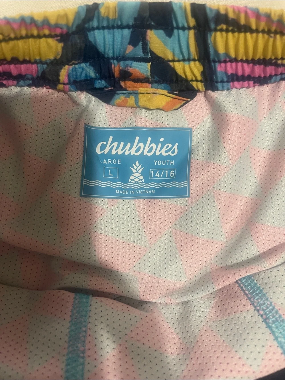 chubbies Kids Neon Geometric Swim Trunks in Pink, Blue, Yellow, Black